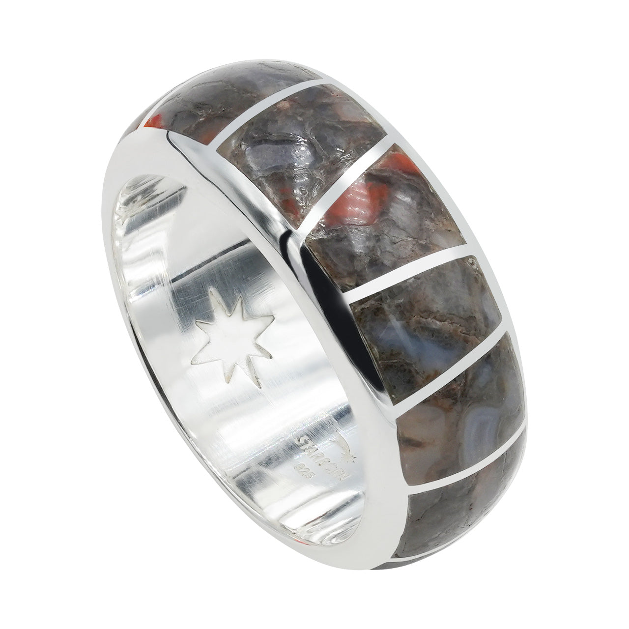 Angled view of a sterling silver channel ring showing fossil dinosaur bone inlay