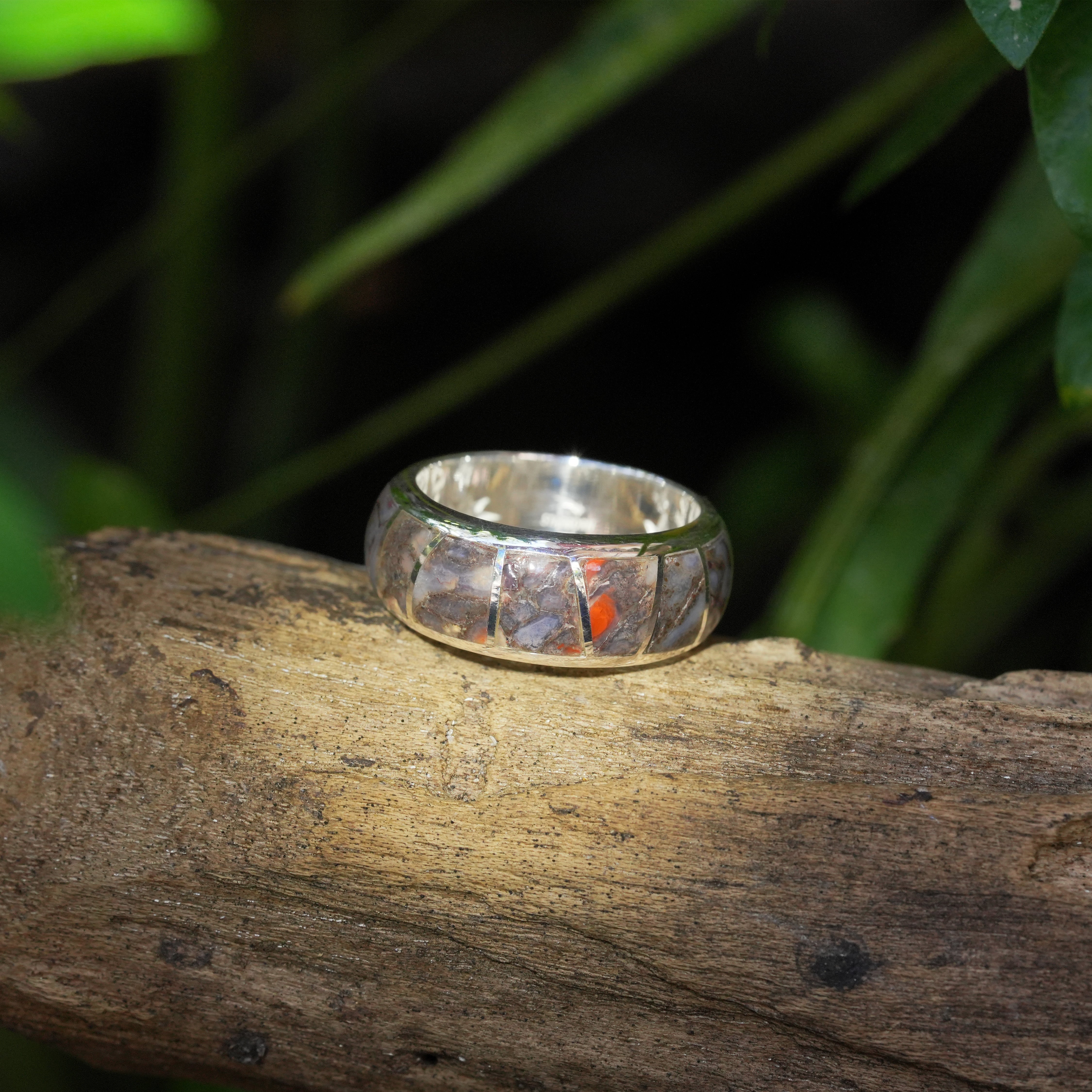 Alternate angled view of a sterling silver channel ring showing fossil dinosaur bone inlay. 